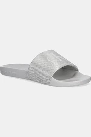Calvin Klein Klapki SLIDE AOP PRINT męskie kolor YM0YM01269