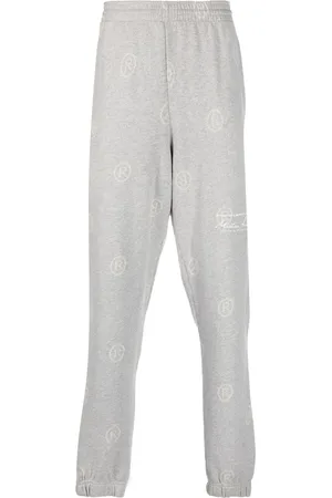 MARTINE ROSE All-over logo-print track pants