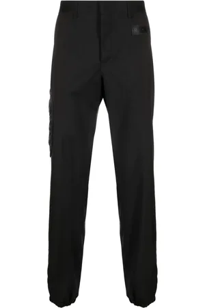 Moschino Rubberised-logo tailored trousers