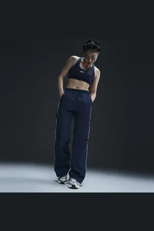 Nike Damskie spodnie z tkaniny z wysokim stanem i luźnymi nogawkami Windrunner