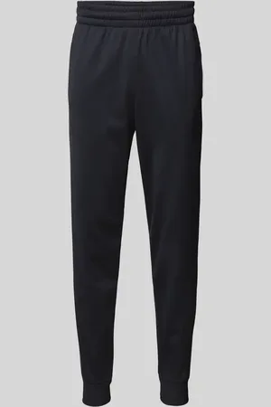 Under Armour Spodnie dresowe o kroju slim fit z nadrukiem z logo