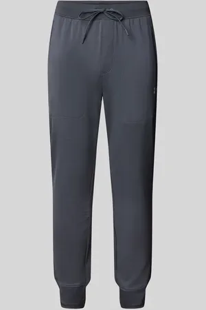 Under Armour Spodnie dresowe o kroju regular fit z kieszeniami zapinanymi na zamek błyskawiczny model ‘Vanish’