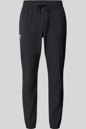 Under Armour Spodnie treningowe o kroju relaxed fit z nadrukiem z logo model ‘Vibe’