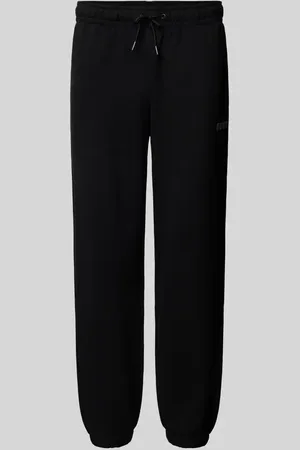 Guess Spodnie dresowe o kroju relaxed fit z nadrukiem z logo model ‘EMIS’