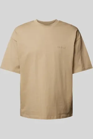 Review T-shirt o kroju oversized z nadrukiem z logo