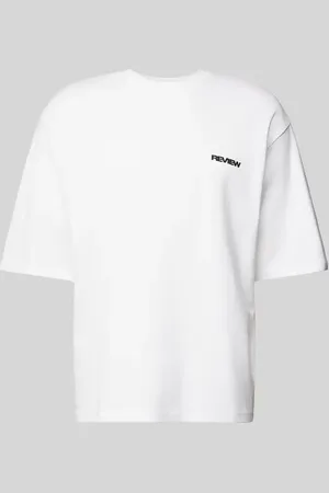 Review T-shirt o kroju oversized z nadrukiem z logo