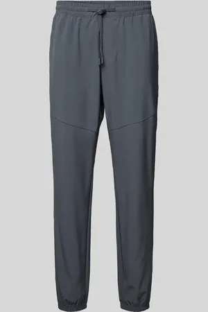 Under Armour Spodnie treningowe o kroju relaxed fit z nadrukiem z logo model ‘Vibe’