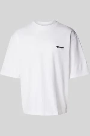 Review T-shirt o kroju oversized z nadrukiem z logo
